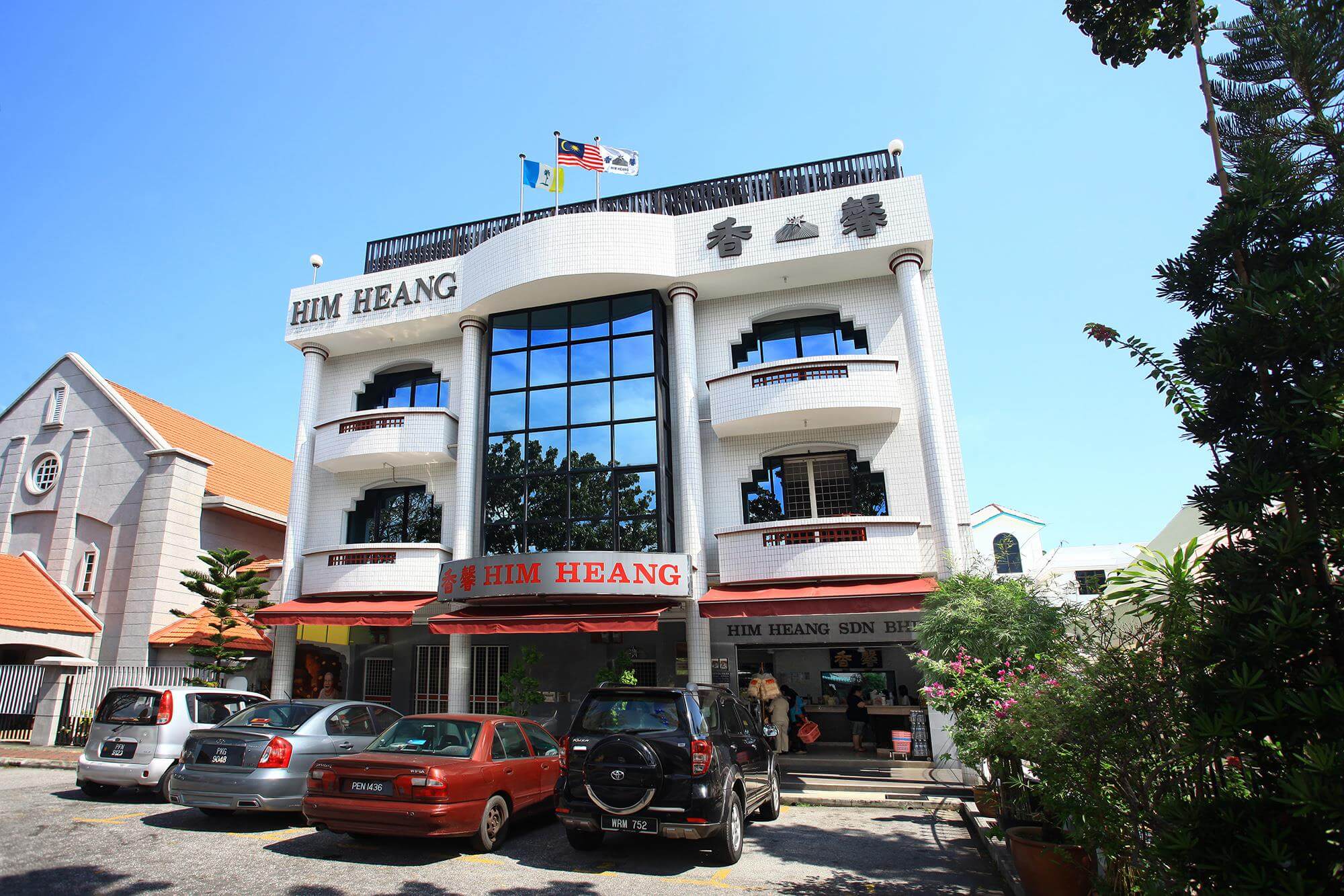 a white three storey building in Penang