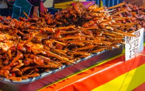 pieces of grilled chicken displayed on a street stall at the Ramadhan bazaar