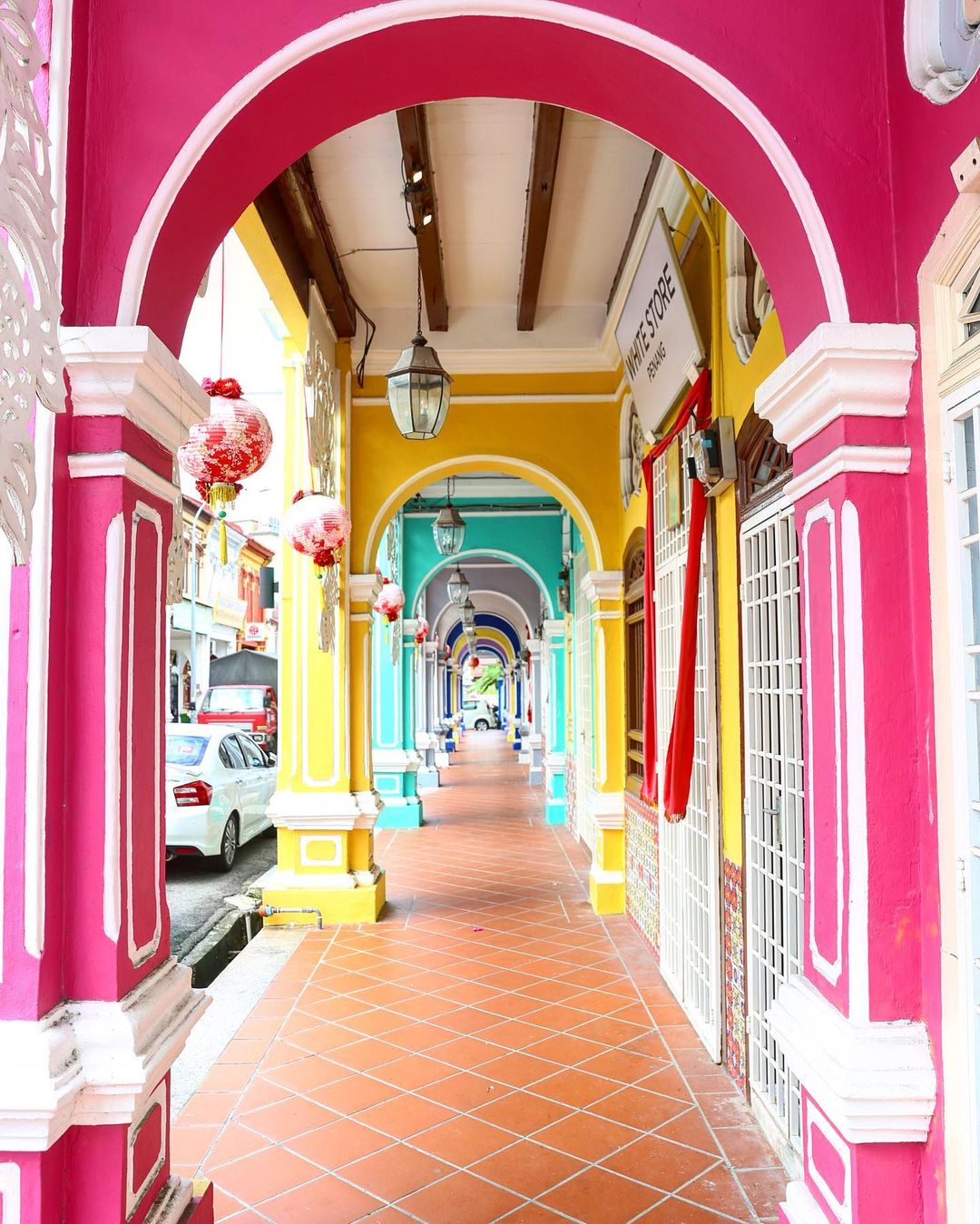 stretch of walkway with colourful pillars