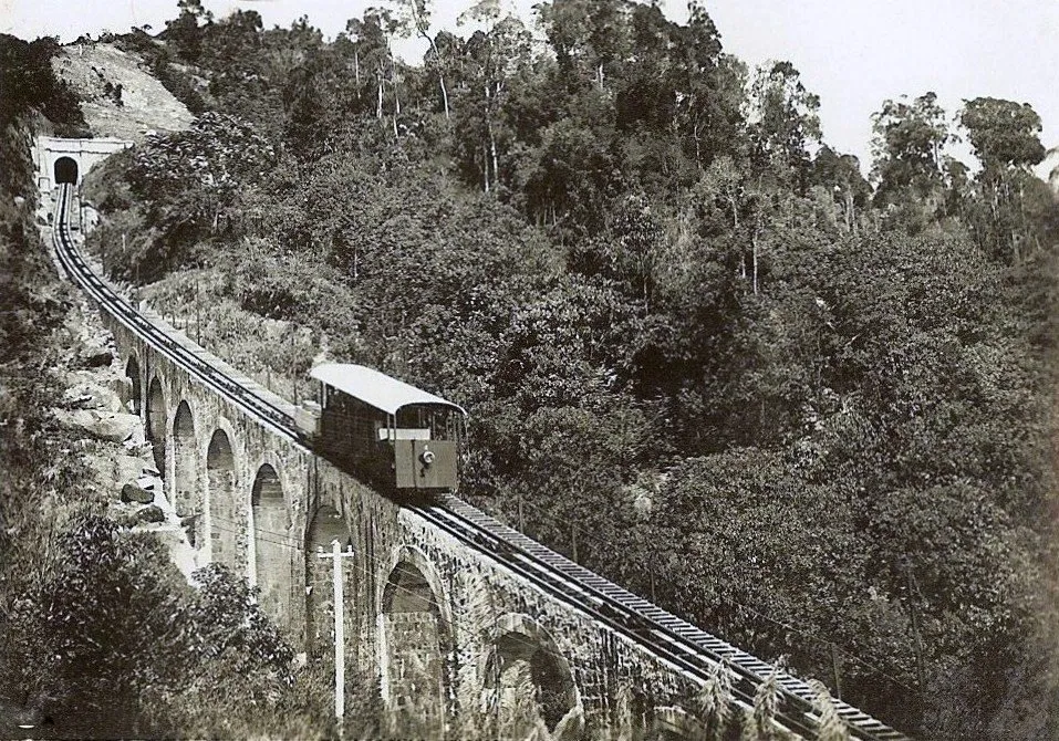 a funicular train moving through its track up the hill