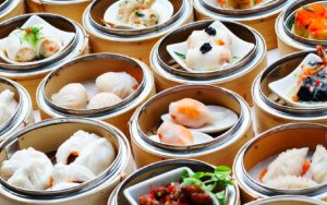 variety of different dim sum dishes served in bamboo baskets