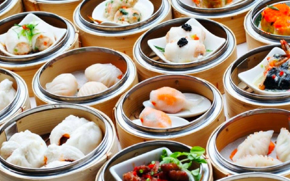 variety of different dim sum dishes served in bamboo baskets