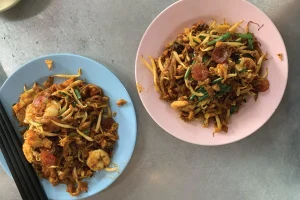 A flatlay image of two plates of Penang Char Koay Teow