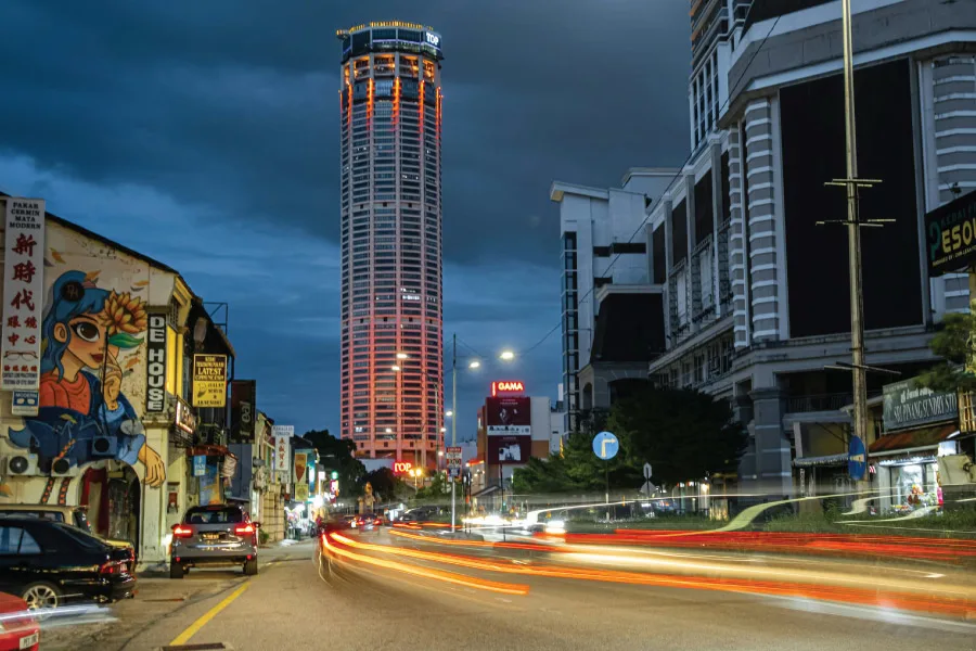 an evening scene in a city with skyscraper at the background
