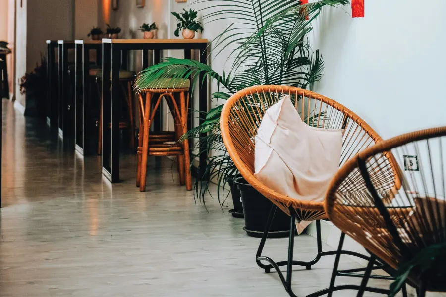 interior of a cafe with rattan chair and bar tables