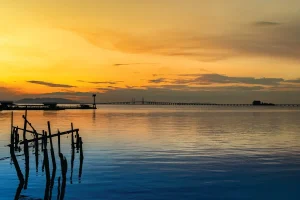 overlooking a bridge across the sea with a sunrise view