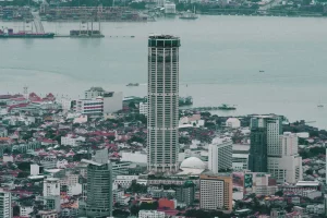 a skyscraper standing tall amongst lower buildings