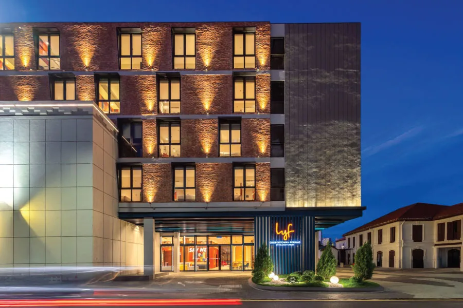 facade of building with lights on in the late evening